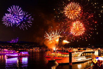 Fototapeta premium Rhine in Flames in Germany is an event where passing ships are decorated with lights and fireworks illuminate the river at night.