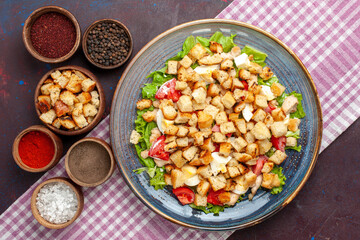 top view tasty caesar salad with little rusks and seasonings on the dark-purple desk salad food meal lunch vegetables