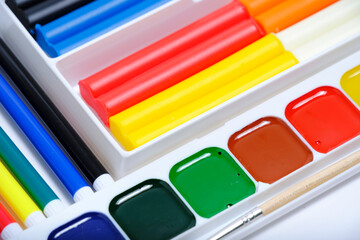Children, school set for creativity and drawing from watercolor paints, felt tip pens and plasticine.Bright abstract background.