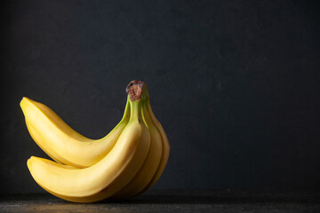 front view fresh yellow bananas on a dark background exotic fruit ripe food darkness tropical taste photo