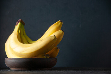 front view fresh yellow bananas on dark background exotic fruit ripe food darkness tropical taste photo mellow