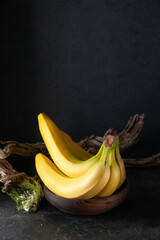 front view fresh yellow bananas on the dark background exotic ripe food darkness taste photo...