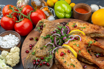 front view tasty fried fish with vegetables eggs and seasonings on a dark background color salad meal ocean dough food health meat seafood
