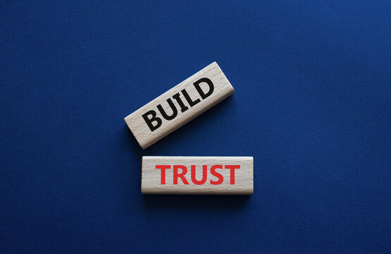 Build trust symbol. Wooden blocks with words Build trust. Beautiful deep blue background. Business and Build trust concept. Copy space.