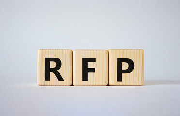 RFP - Request for Proposal. Wooden cubes with word RFP. Beautiful white background. Business and Request for Proposal concept. Copy space.
