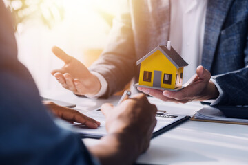 Real estate agent and customer signing contract to buy house, insurance or loan real estate.rent a house,get insurance or loan real estate or property.