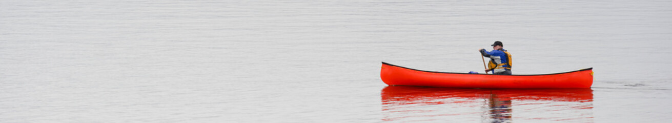 Fototapeta na wymiar Kayak on peaceful calm water on Loch Lomond