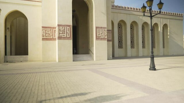 Travelling to the entrance of the Al Fateh mosque with its large arches, in Bahrain 	