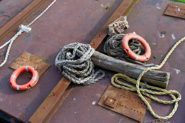 Red buoy life safety ring on pontoon and safety rope