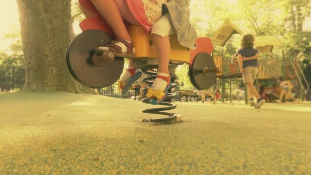 Slow motion shot of unknown kids having fun on the playground in summer