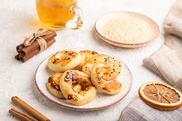 Homemade asian salted cookies, cup of green tea on gray concrete, side view.