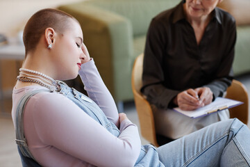 Obraz premium Teenage girl listening to recommendations of psychologist during her visit to office