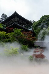 Mist surrounding beautiful Japanese building in the mountains