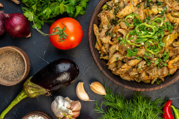 Above view of tasty dinner with eggplant dish fresh vegetables green bundle pepper on dark color table