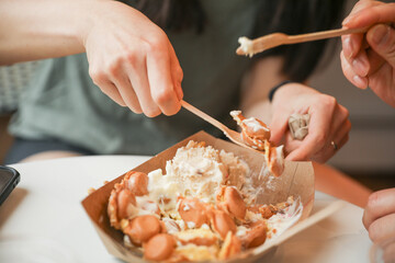 hands eagerly grab and devour food, representing hunger, sustenance, and the primal instinct of...