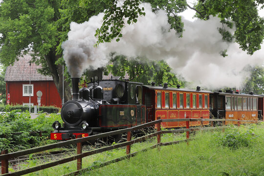 Mariefred, Sweden - July 2, 2023: Narrow gauge old steam train at the Ostra Sodermanland railway museum located in Mariefred, Sweden.