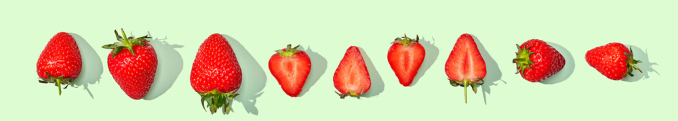 Strawberry with blossom isolated on green pastel background