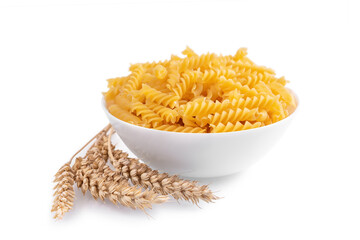Pasta and wheat spikelets isolated on white background, banner, header, template with copy space. Raw pasta fusilli, ingredient for cook, traditonal italian cuisine. Side view