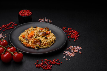 Delicious fresh pilaf with rice, carrots, meat, onions, spices and berries