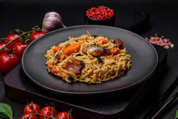 Delicious fresh pilaf with rice, carrots, meat, onions, spices and berries