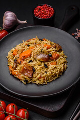 Delicious fresh pilaf with rice, carrots, meat, onions, spices and berries