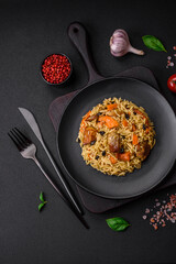 Delicious fresh pilaf with rice, carrots, meat, onions, spices and berries