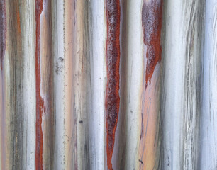 Background with an old metal texture. Rusty, undulating metal fence. Template featuring an abstract design for website, web page, packaging, advertising, design. Gradient of time.