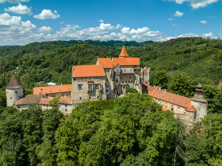 Obraz premium Aerial view of circular corner defensive tower and Gothic palace building at Pernstejn castle