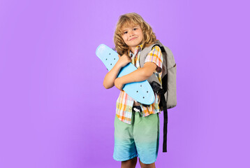 Child with skateboard in the studio. Kid having fun with penny board. Penny board, skateboard for children. Fashion child in shirt.