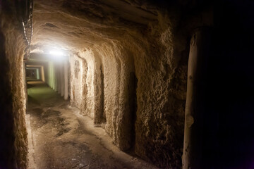 Inside view of dark corridors with lights in old closed mines