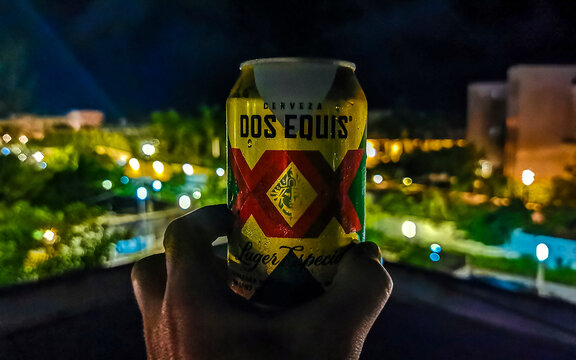 Dos Equis XX beer in the hand tropical landscape Mexico.