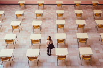 A woman standing in a room full of desks created with Generative AI technology