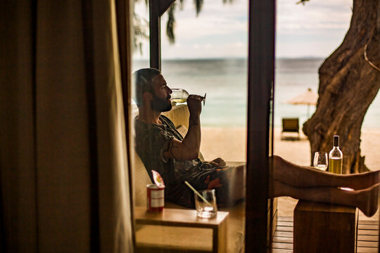 Young man resting in terrace and drinking wine