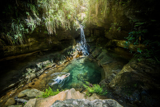 Unrecognizable man swimming in falling water