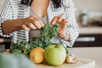 Person tearing kale 
