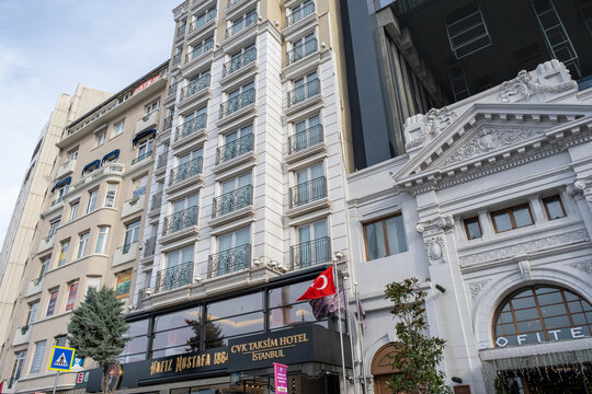 Beyoglu, Istanbul, Turkey - 02.17.2021: buildings of luxurious CVK Taksim Hotel in Taksim Avenue and Hafiz Mustafa Turkish dessert cafe since 1864 low angle view