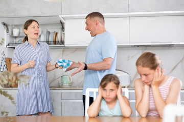 Couple sort things out and yell at each other in kitchen. Parents quarrel behind back of their...
