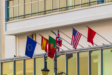 National flags of the European Union, Spain, Portugal, France, the United States and the Kingdom of Morocco, mounted on a flagpole on a street in the city of Tangier, Morocco. Cooperation, diplomacy.