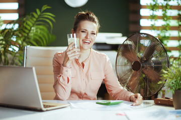 happy modern accountant woman at work with electric fan