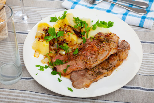 Appetizing grilled pork loin chops with boiled potato