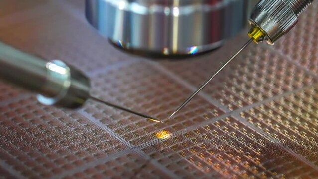 Check Micro Electronic Chip Under A Microscope.