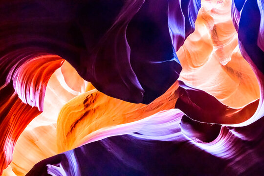 Abstract sandstone underground canyon cave with strong light and orange, red and purple color.