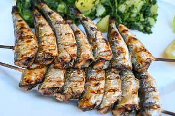Grilled pilchard. Tasty Sardines served on plate in restaurant. Delicious fish on barbeque.