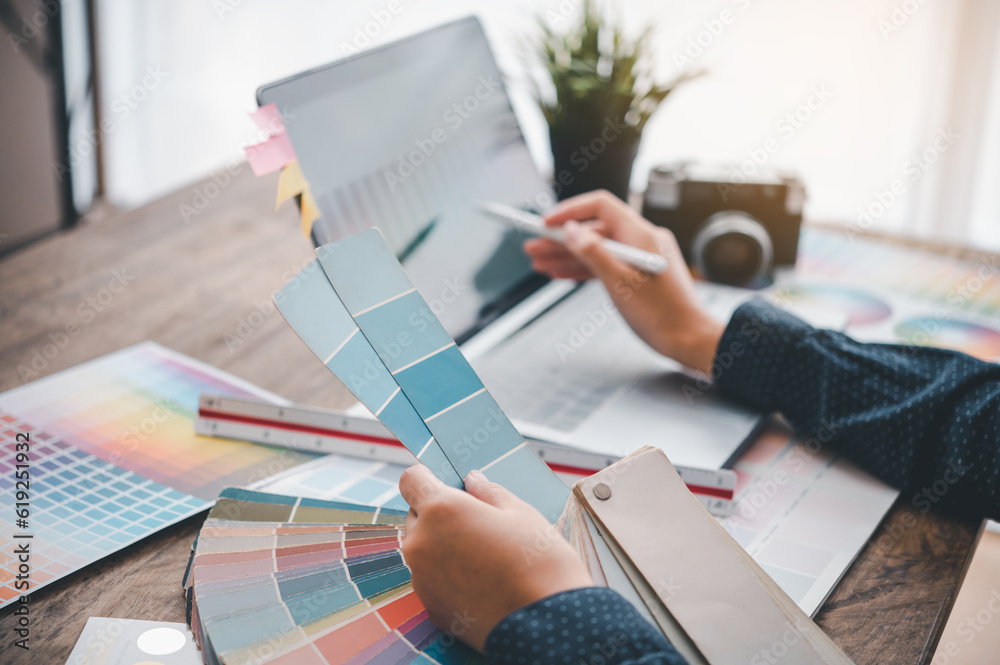 Fototapete Graphic designer architects who work with laptops and color comparison tables for design work..