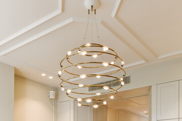 a kitchen with white cabinets and light fixtures on the ceiling above it is a chandel that has been installed