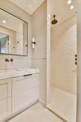 a modern bathroom with white cabinets and marble counter tops on the vanity, along with a walk - in shower