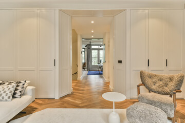 a living room with white walls and hardwood flooring the room is decorated in neutral tones, including wood floors