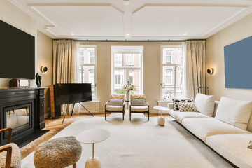 a living room with couches, chairs and a flat screen tv on the wall in front of the fireplace