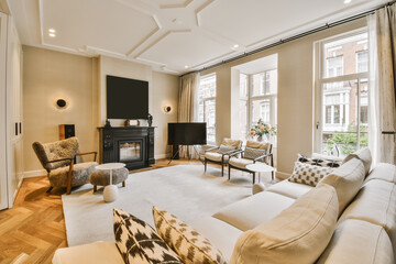 a living room with couches, chairs and a fire place in the middle part of the room on the right side