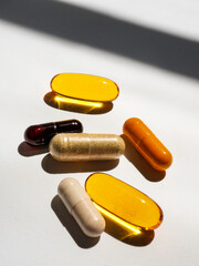 Group of pill capsules on white background with shadow